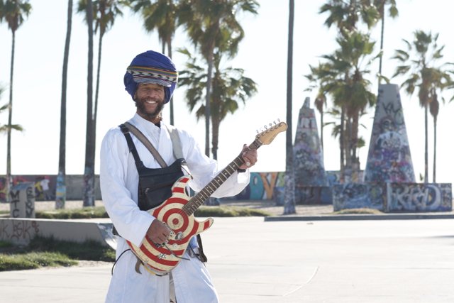 Turbaned Guitarist Shreds by the Palm Trees