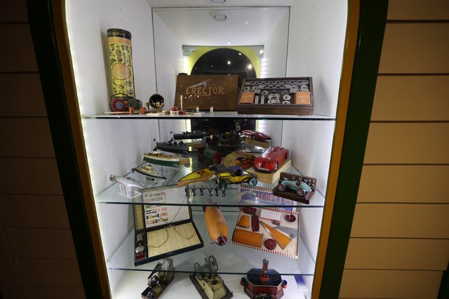 Vintage Toy Collection Display in Illuminated Cabinet