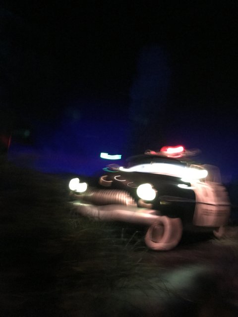 Blurred Police Car Patrols at the Park at Night