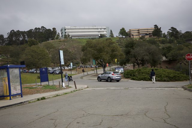 Modern University Campus on Hillside Under Overcast Sky
