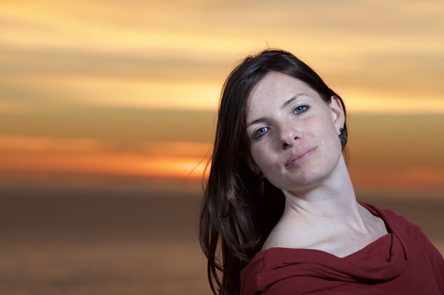 Woman in Red Against a Golden Sunset Sky