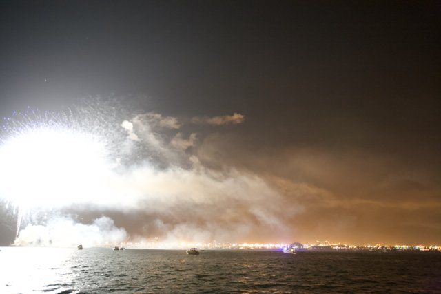 Fireworks Illuminating the Night Sky over the Ocean
