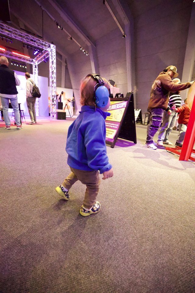 Child with Headphones at Interactive Museum Exhibit