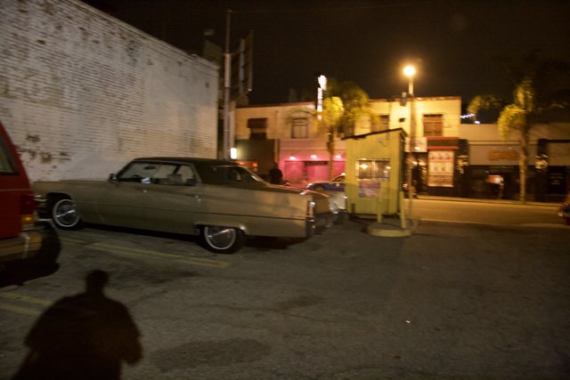 Nighttime Coupe Parked in Front of Building