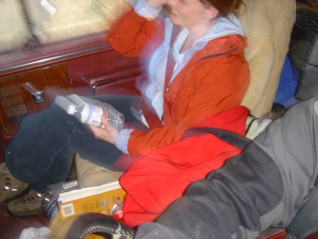 Laughing Woman with Water Bottle in Vehicle