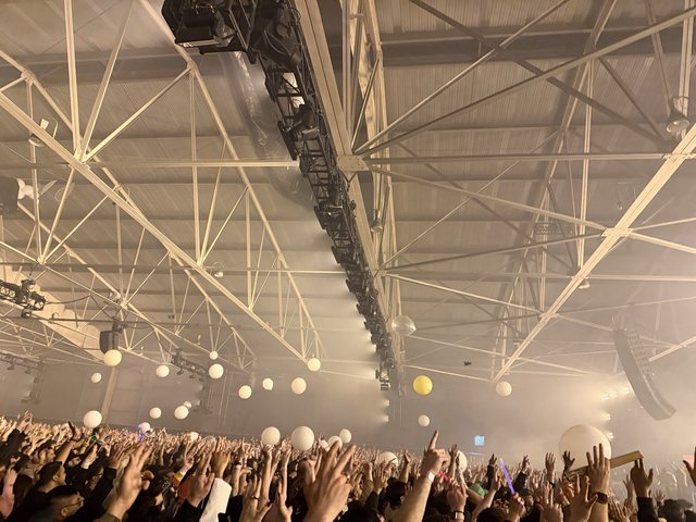 Skrillex and Four Tet Concert Crowd in Industrial Venue