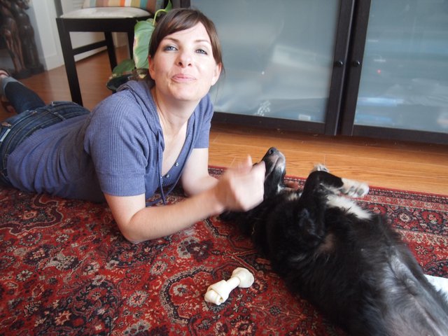 Woman Playfully Bonding with Dog on Living Room Rug