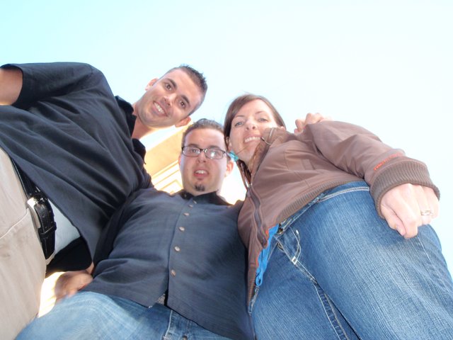 Three Friends Grinning Down at a Worm's-Eye Camera
