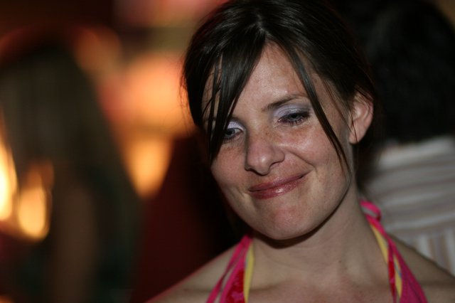 Candid Smiling Woman by Warm Firelight Glow