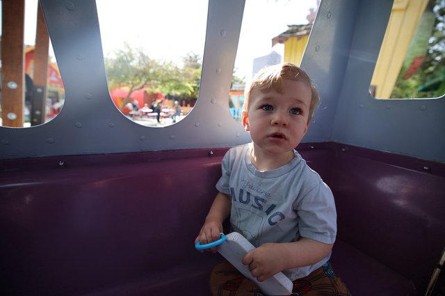 Toddler Playing in Carnival Ride at Fantasyland