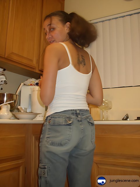 Woman in Jeans Poses in Kitchen