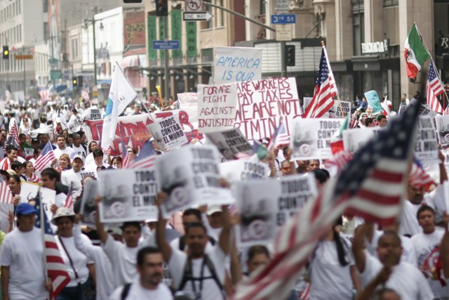Patriotic Protesters March Down the Street with Flags and Signs