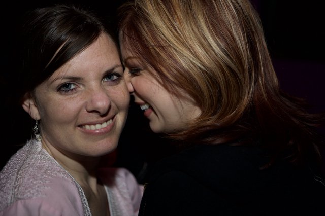 Two Friends Share a Joyful Moment at Night Event