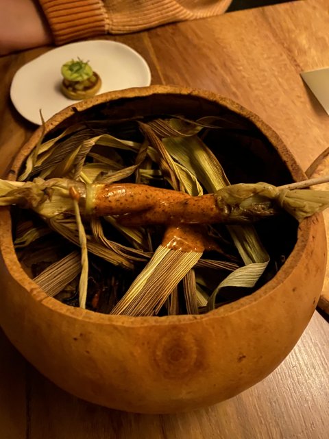 A rustic wooden bowl filled with fresh produce