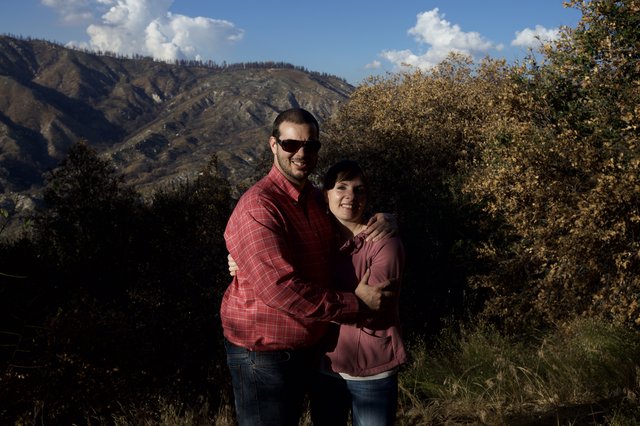 Couple Embracing in Mountain Landscape at Sunset