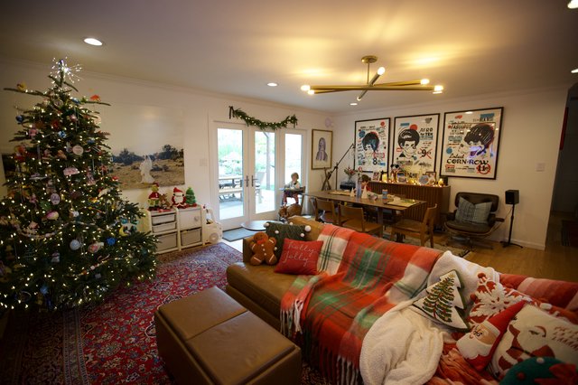 Cozy Christmas Living Room with Decorated Tree and Vintage Posters