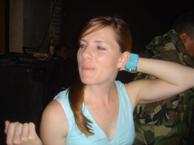 Woman with Black Eye at Nighttime Social Gathering