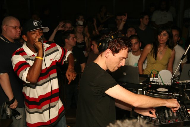 Nightclub DJ in Black Shirt with Hat and Headphones