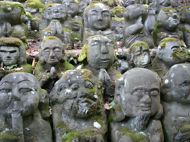 Faces of Time Covered in Moss