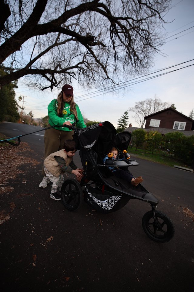 Mother with Children on Evening Neighborhood Stroller Walk