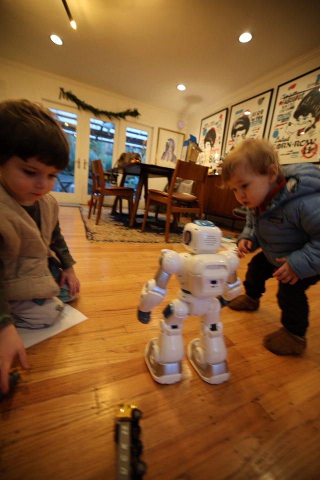 Children Discover Interactive White Robot at Home