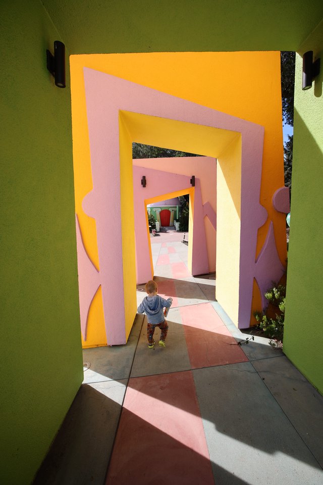 Child Exploring Colorful Geometric Portal Tunnel