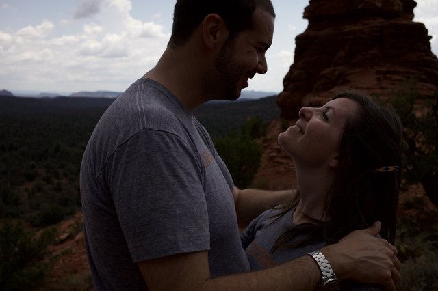 Laughing Couple Embracing Atop Sedona Red Rocks