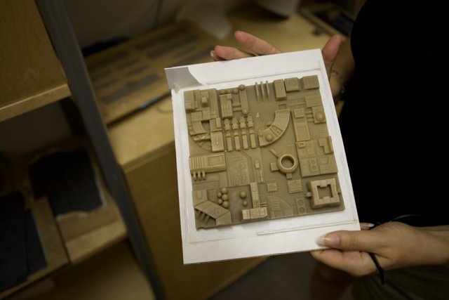 Paper Model of Building in Hands