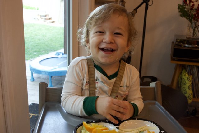 Joyful Toddler at Mealtime on Christmas Eve