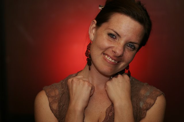 Smiling Woman in Red Light Portrait Session