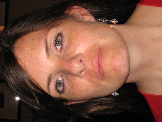 Freckled Woman in Red at Evening Gathering