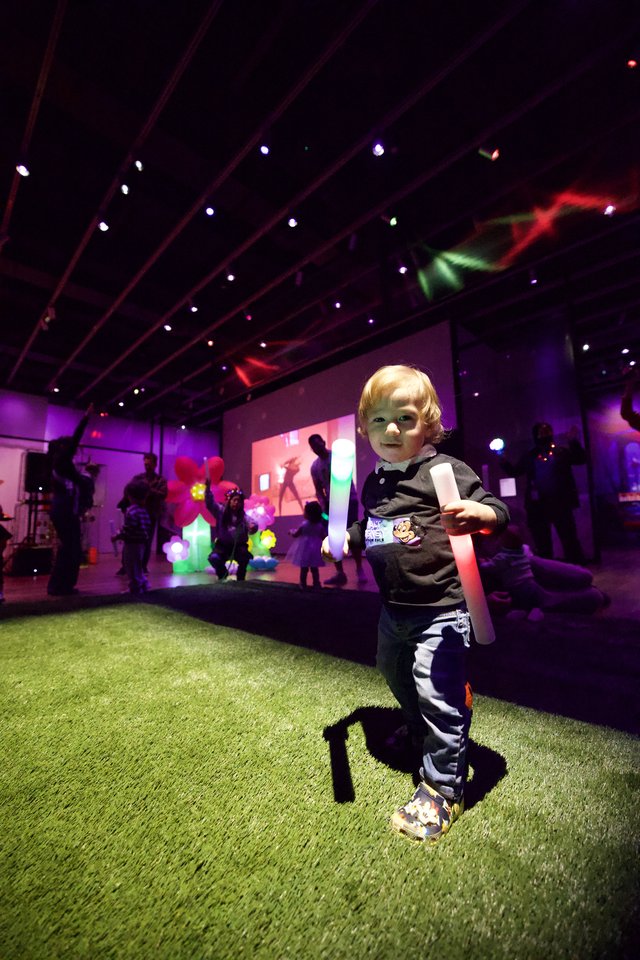 Young Child at Baby Rave Event with Glow Stick