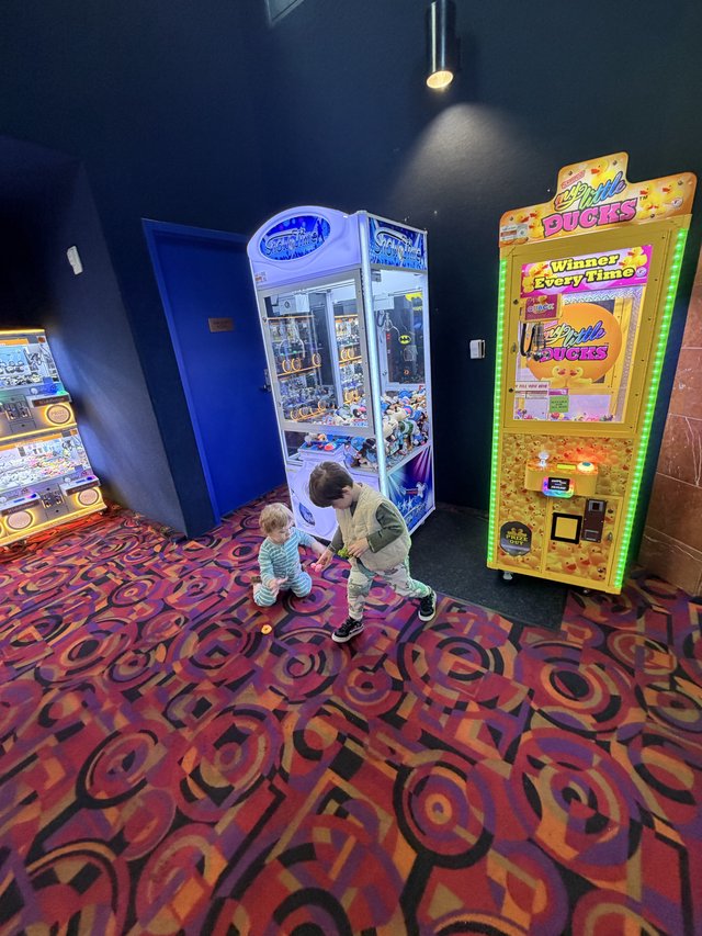 Children Playing at Arcade Game Machines