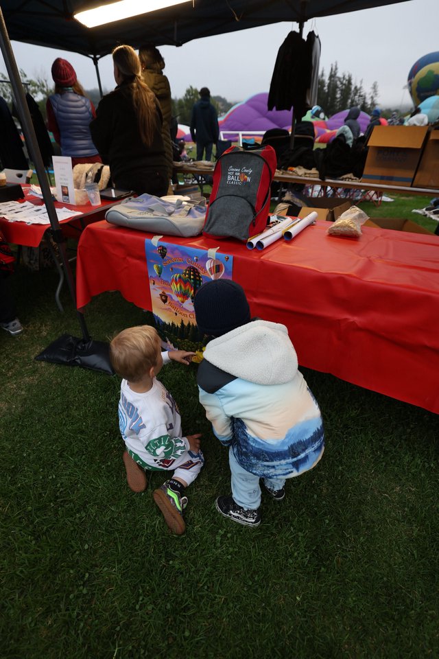 Young Children Explore Hot Air Balloon Festival Booth