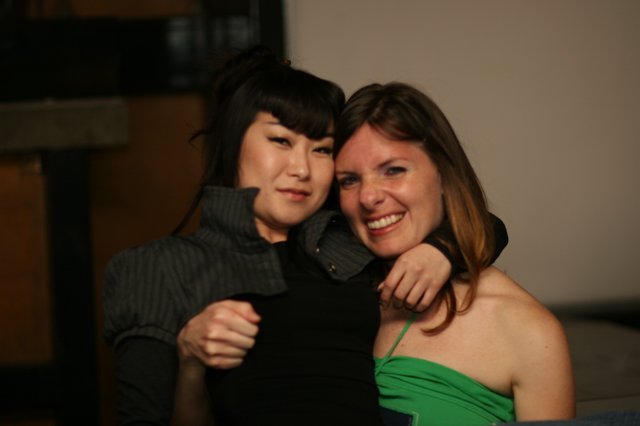 Two Friends Share a Warm Embrace at Party