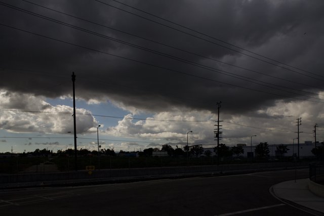 A Dark Sky over Power Lines and Street