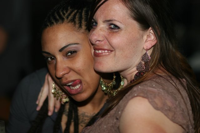 Two Friends Sharing a Joyful Moment at Nightclub
