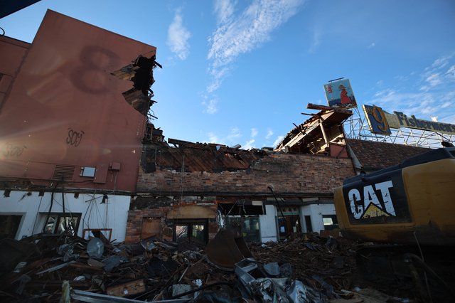 Urban Demolition Site with CAT Excavator at Dusk