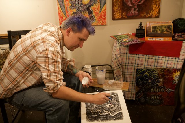 Purple-haired artist creating masterpiece on paper