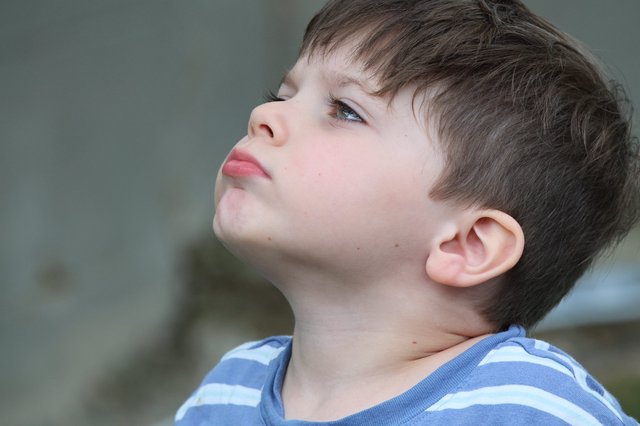 Young Boy Looking Upward in Contemplative Profile Portrait