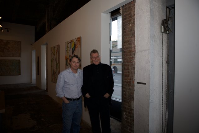 Two Men Admiring Art in a Corridor