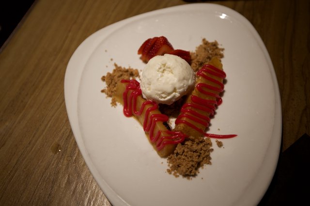 Artfully Plated Dessert with Ice Cream and Strawberry Coulis