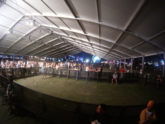 Nighttime Crowd under Tent Canopy