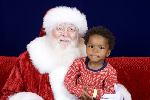 Santa Claus and Child Pose for Festive Photo