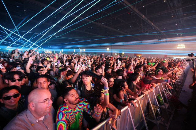 Massive Crowd Illuminated by Laser Light Show