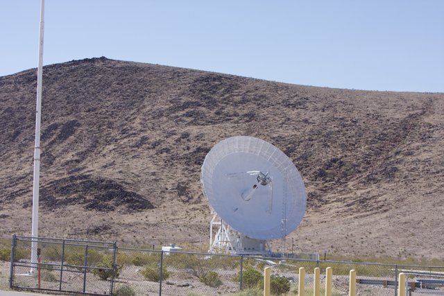 Radio Telescope Among the Rough Desert Landscape