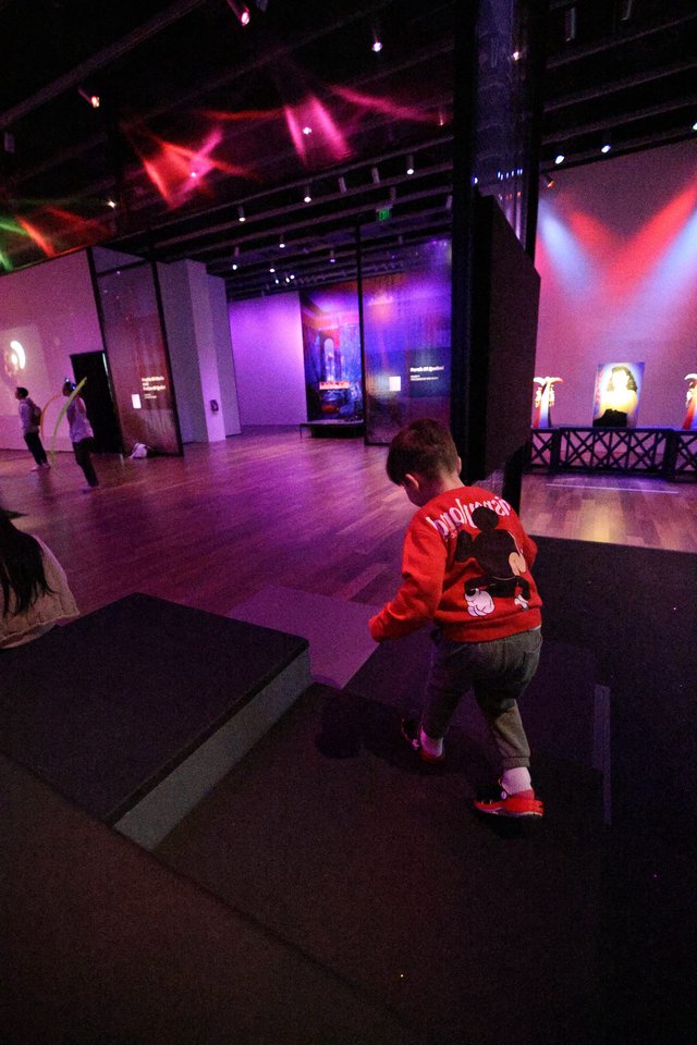 Child Exploring Modern Art Exhibition Space