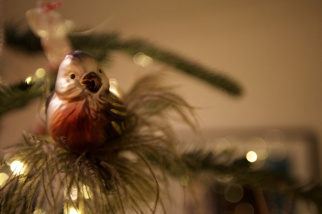 Singing Bird Christmas Ornament on Illuminated Tree