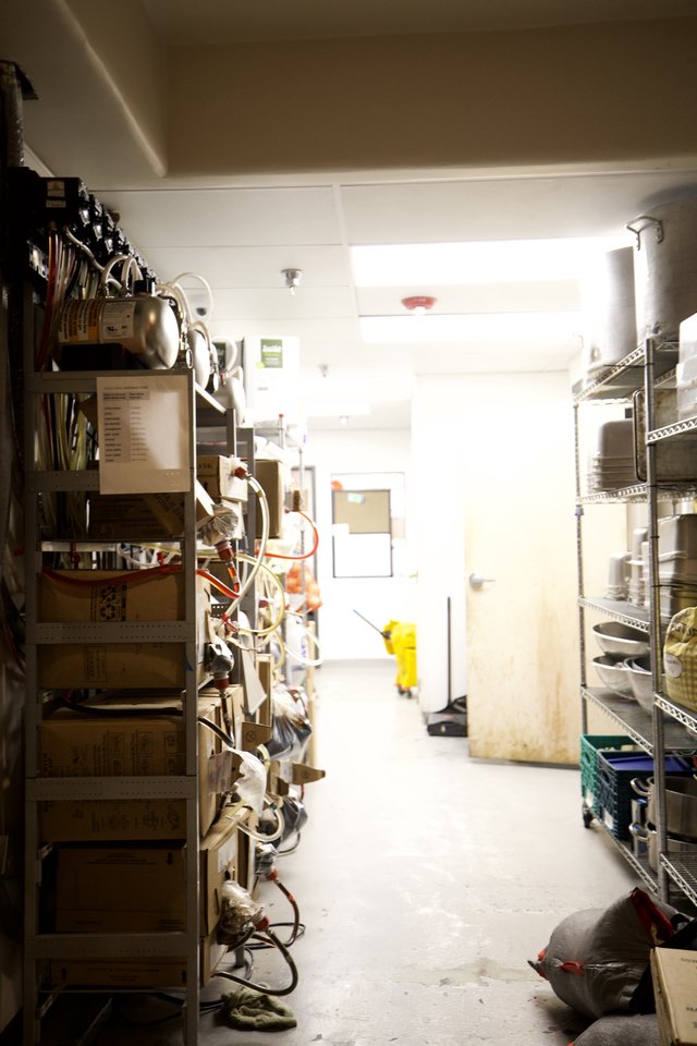 Narrow Commercial Kitchen Storage Corridor with Bright Natural Light