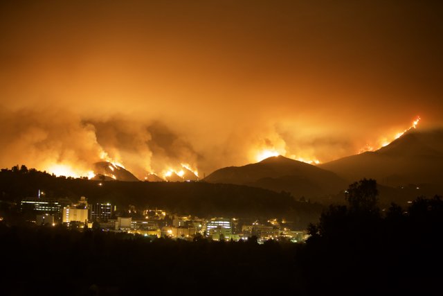 Blaze Erupts in Mountains, Threatening City